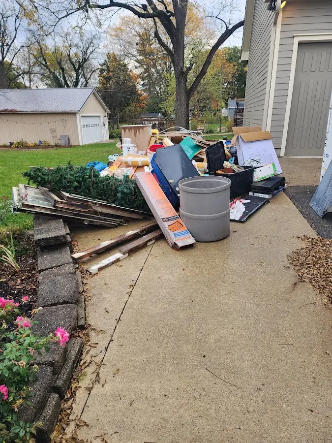 Dumpster being loaded with debris for 12 Yard Dumpster Rental in Goffstown
